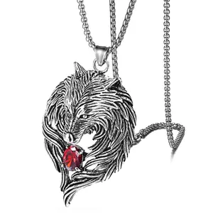 Vintage wolf head pendant necklace in stainless steel with a red gemstone on white background