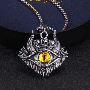 Gothic Evil Eye necklace with three skulls and orange dragon eye in vintage silver finish