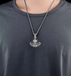 Detail of Viking battle axe pendant with Valknut symbol on vintage steel chain