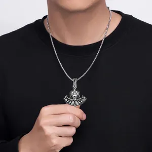 Close-up of vintage Viking battle axe pendant with Valknut symbol and metallic chain link