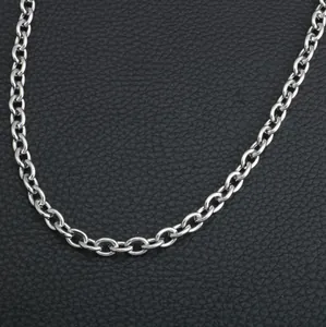 Polished silver stainless steel cable chain necklace on a black leather background
