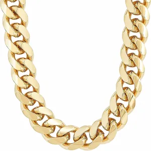 Macro shot of polished gold-colored Cuban link chain with thick interlocking metal rings