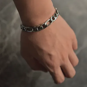 Silver Figaro chain bracelet for men in stainless steel worn on wrist detail view