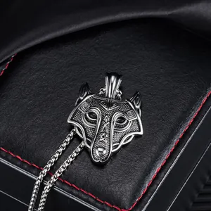 Macro view of Celtic wolf head pendant with intricate Norse knotwork on a black leather stand