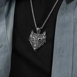 Detailed view of a Viking wolf head necklace with vintage finish worn by a model