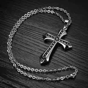Retro stainless steel cross pendant necklace with black stones on dark background