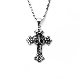 Detailed macro view of vintage stainless steel cobra snake on a textured cross pendant