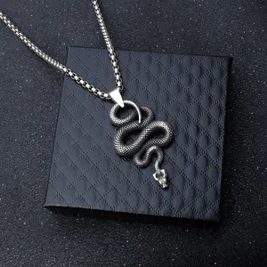 Vintage stainless steel snake pendant necklace with detailed scales on black jewelry box