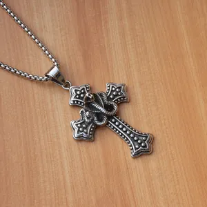 Detailed close-up of a vintage silver gothic snake and cross pendant with box chain