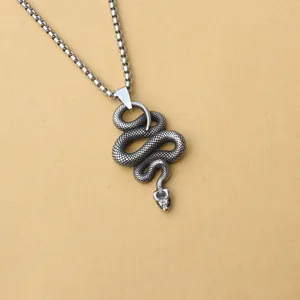 Macro shot of detailed scales on a vintage Viking snake pendant with sturdy box chain