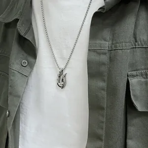 Close-up of men stainless steel tribal hook pendant necklace on a streetwear model