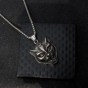 Detailed close-up of a roaring wolf head pendant in silver stainless steel finish