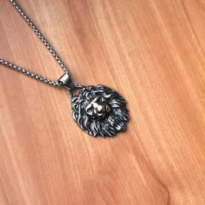 Dettaglio ravvicinato di una collana con ciondolo a testa di leone su sfondo di legno