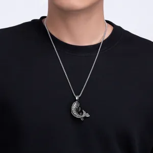 Men's titanium koi fish pendant necklace with vintage silver finish on black hoodie