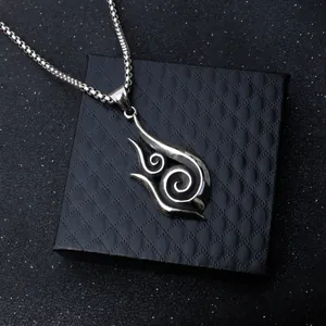 Retro stainless steel flame pendant with box chain on a black gift box background