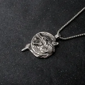 Detailed close-up of a silver Viking wolf head pendant with Nordic spiral patterns