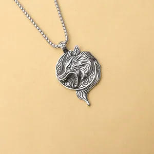 Detailed close-up of a Viking wolf head pendant with antique finish on box chain