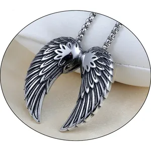 Detailed macro shot of vintage silver angel wing pendant with textured feathers