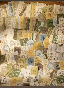 Close-up of vintage aesthetic scrapbooking stickers featuring retro patterns and antique textures