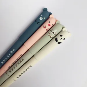 Close-up of four erasable gel pens with cute 3D cartoon pig and panda toppers