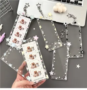 Macro view of clear acrylic card holder with colorful stars and metal star keychain