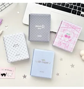 Detail of four colorful PVC photo albums with wing patterns and magnetic closures