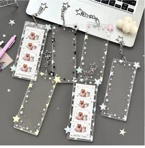 Detail of clear acrylic card holder with colorful star patterns and star-shaped metal clip