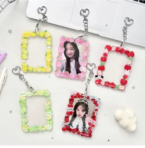 Detail of five fruit-themed acrylic card holders with heart-shaped metal clasps