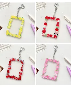 Detailed view of acrylic fruit-themed photo card holders with heart-shaped metal clasps