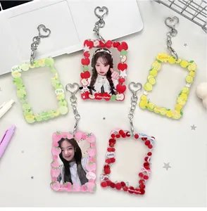 Detailed flat lay of five fruit-themed acrylic photocard holders with heart-shaped metal clips