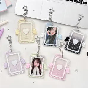 Flat lay of colorful acrylic card holders with angel wings and star-shaped keychains