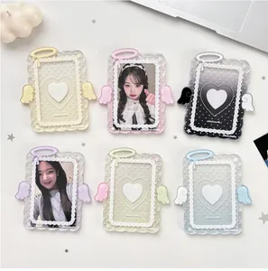 Flat lay of angel wing acrylic photocard holders in six colors on white desk
