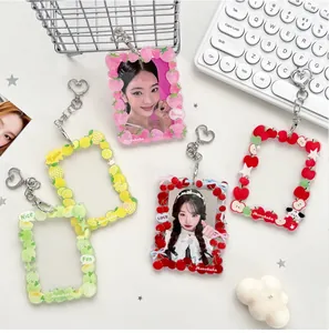 Detail showing colorful acrylic fruit photocard holders with heart shaped metal hooks