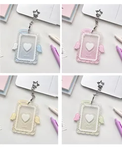 Detail of four colorful acrylic card holders with angel wings and star keychains