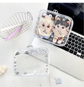 Top view of a transparent PVC doll storage bag with cat motifs and a silver zipper