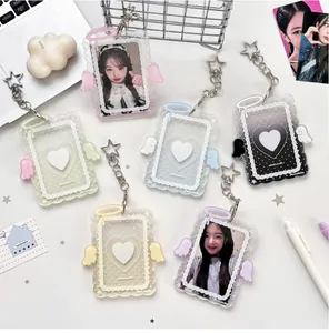 Close-up of assorted cream angel wing acrylic photocard holders with star keychains