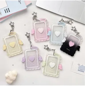 Detail of colorful acrylic photocard holders with cream angel wings and star keychains
