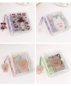 Detail of four transparent 3-hole PVC mini photo albums with cute cartoon designs