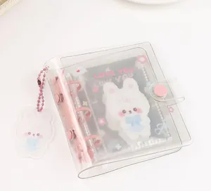 Detail of pink binder mechanism and cute rabbit pendant on clear PVC photo album