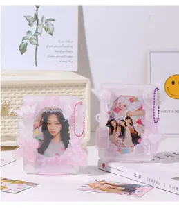 Close-up of pink acrylic photo card holders with cute wing and bow 3D decorations