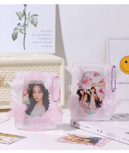 Detail view of pink acrylic K-pop photocard holders with cute 3D charms and punk design