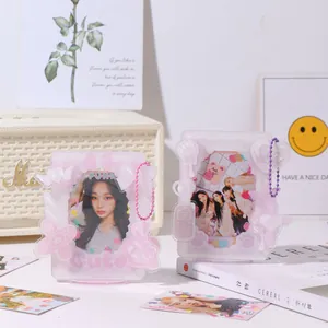 Pink acrylic photocard display stand with cute bow and wing details and bead chain