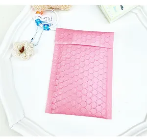 Close-up of a bright pink padded bubble mailer with self-adhesive seal and textured surface