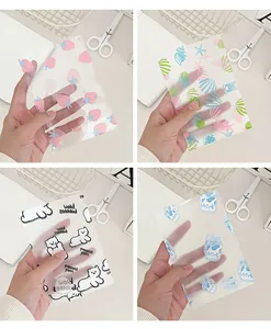 Detail view of cute translucent cartoon storage bags featuring strawberry and bear patterns