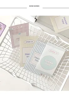 Mini pastel decorative seal cards with thank you text in a white wire basket display