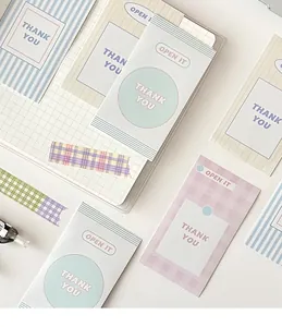 Detail of macaron-colored 'THANK YOU' gift stickers and matching checkered washi tape