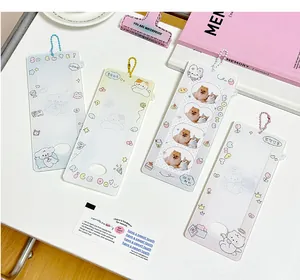 Detailed view of cute cartoon acrylic photocard holders with colorful bead chains on a desk