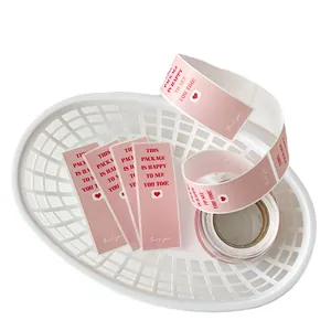 Pink rectangular seal stickers with 'Happy to see you' text and red hearts on a roll