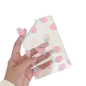 Cute strawberry print transparent PVC storage pouch for cards and stationery in handheld view