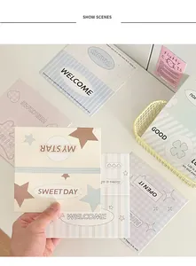 Close-up of minimalist Morandi-style decorative cards with stars and sweet phrases